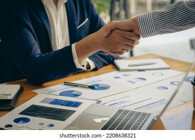 business people shake hands to make an agreement during a board meeting in the office Teamwork, agreement, cooperation, real estate business concept. - Shutterstock ID 2208638321
