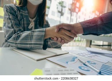 business people shake hands to make an agreement during a board meeting in the office Teamwork, agreement, cooperation, real estate business concept. - Shutterstock ID 2208638327