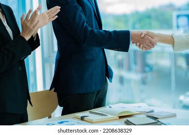 business people shake hands to make an agreement during a board meeting in the office Teamwork, agreement, cooperation, real estate business concept. - Shutterstock ID 2208638329
