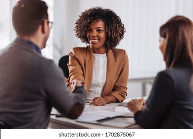 Business people shaking hands after meeting - Shutterstock ID 1702875067