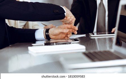 Business people shaking hands after contract signing in modern office. Teamwork and handshake concept - Shutterstock ID 1810059583