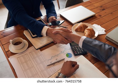 Business people shaking hands before meeting - Powered by Shutterstock