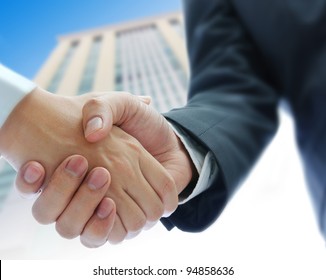 Business People Shaking Hands  Building Background