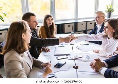 Business people shaking hands, finishing up a meeting - Shutterstock ID 1662296458