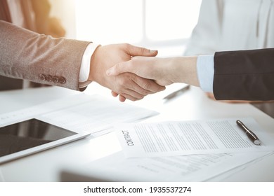 Business people shaking hands finishing contract signing in sunny office, close-up. Handshake and marketing - Shutterstock ID 1935537274