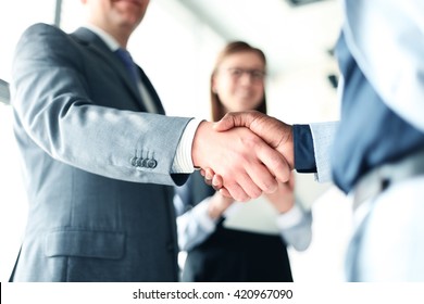 Business people shaking hands, finishing up a meeting - Shutterstock ID 420967090