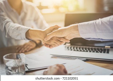 Business people shaking hands, finishing up meeting. Successful businessmen handshaking after good deal. - Shutterstock ID 721102051