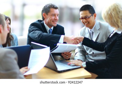 Business people shaking hands, finishing up a meeting - Shutterstock ID 92412247