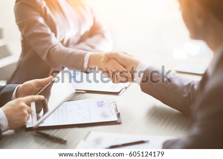 Business people shaking hands, finishing up meeting