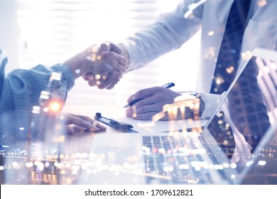 Business People Shaking Hands And Night Cityscape, Closeup. Multiple Exposure 