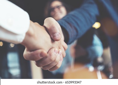 Business People Shaking Hands In The Office After Successful Meeting. Three Persons