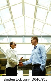 Business People Shaking Hands With A Smile Concluding A Deal Or Greeting Each Other