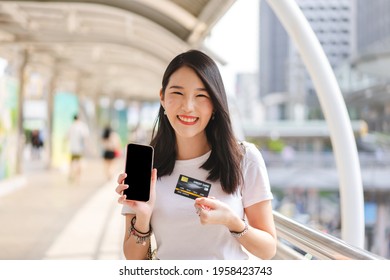 Business People Shopping Via Online Application Media For Cashless Concept. Young Adult Woman Consumer Holding Smartphone For Cyber Banking . Blank Screen Space For Mockup. 