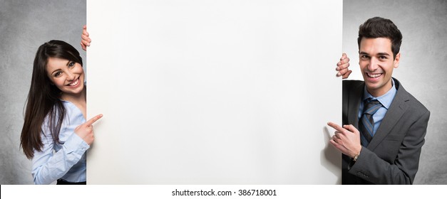Business people showing an empty banner - Powered by Shutterstock
