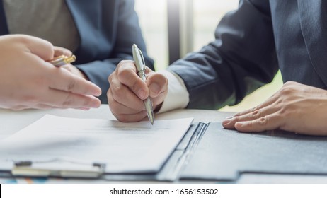 Business People Signing A Contract To Buy Or Sell Real Estate.