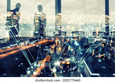 Business people silhouette over an illuminated modern city with network effects - Shutterstock ID 2025775460