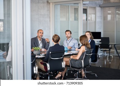 Business people sitting in boardroom and working together at new strategy plan. Group of leader and businesspeople in a meeting at office. Senior executive with his team working in a conference room.