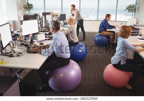 Business People Sitting On Exercise Balls Stock Photo Edit Now