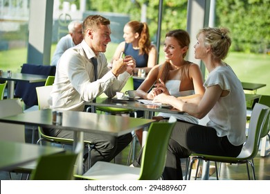 Business People Sitting At Table In A Restaurant For A Meeting