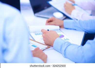 Business people sitting and writting at business meeting, in office - Shutterstock ID 324252503