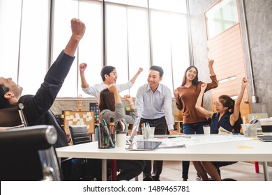 Business people smile and raise hands up, feeling happy, complete finish job, teamwork successful/achievement working in office concept