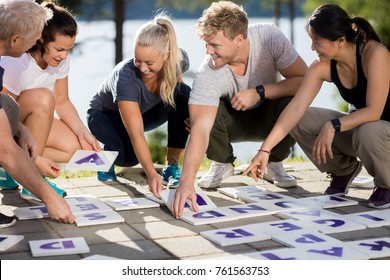 Business People Smiling While Solving Crossword On Patio - Powered by Shutterstock