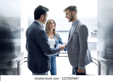 Business People Stretching Out Their Hands For A Handshake