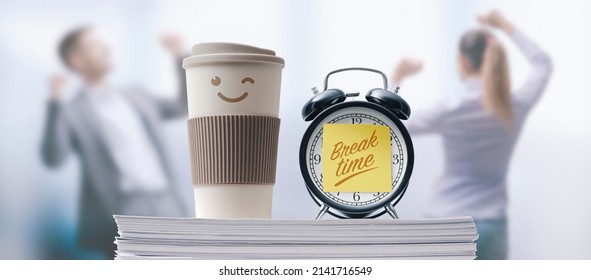 Business people taking a break in the office, alarm clock with sticky note in the foreground - Shutterstock ID 2141716549