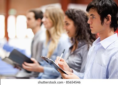 Business People Taking Notes During A Presentation