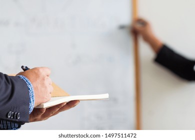 Business people are taking notes while meeting to plan business strategies.