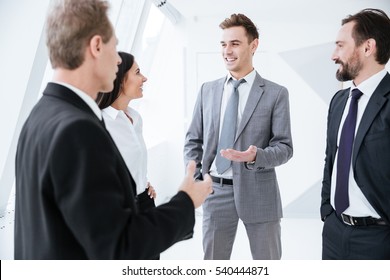 Business People Talk Near The Window In Conference Room