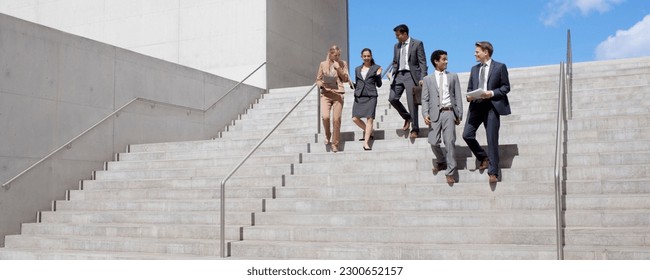 Business people talking and descending urban stairs - Powered by Shutterstock