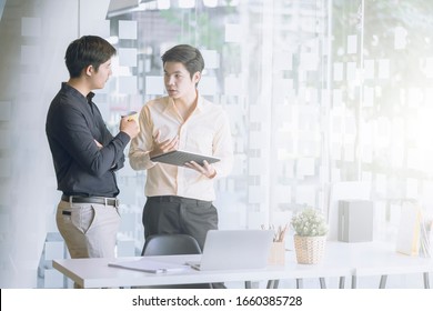 Business People Talking During Coffee Break In Modern Office Or Coworking Space. Young Asian Business Relaxing After Working Time.