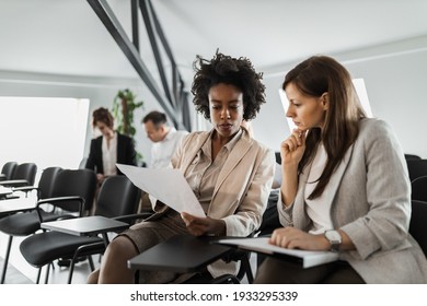 Business people talking to each others. - Shutterstock ID 1933295339