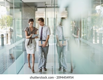 Business People Talking In Office Hallway