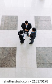 Business People Talking In Office Lobby, View From The Top