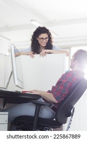 Business People Talking Over Cubicle Wall