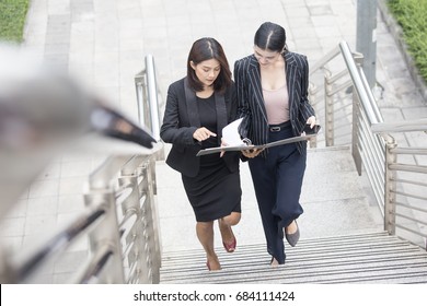 Business People Talking For Business Plan While Walking. Woman Walking Concept. 20-30 Year Old.