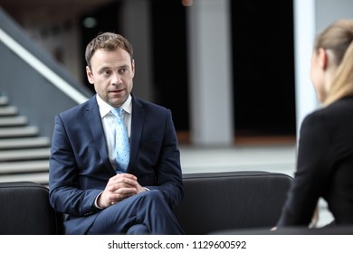 Business People Talking Sitting On Sofa At Office Lobby, Break, Interview Concept