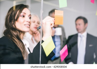 Business People Talking And Writing Notes On The Post It Cards