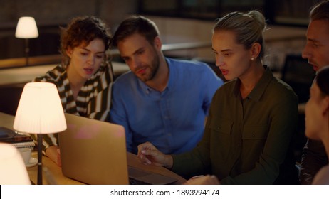 Business People Team Analyzing Data On Laptop Computer In Office. Business Woman Leaving Workspace In Creative Office Space At Night. Young Businesswoman Remaining Work On Computer In Evening Office