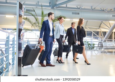 Business people as a business team with luggage on business trip in airport terminal - Powered by Shutterstock