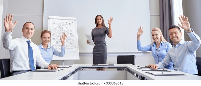 Business, People And Teamwork Concept - Group Of Smiling Businesspeople Meeting And Waving Hands In Office