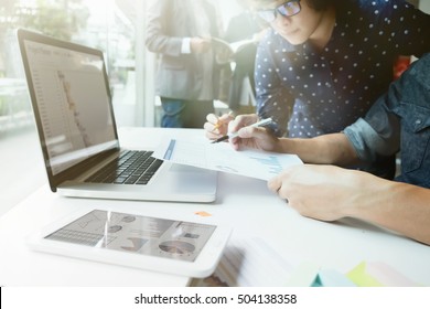 Business people teamwork meeting to discuss the situation on the market. Selective focus  man's hand holding the business chart. - Shutterstock ID 504138358