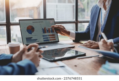Business people, teamwork and meeting for strategy, planning or corporate brainstorming discussion at office. Business people meeting explaining the financial graph data and marketing plan.