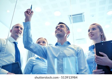 business, people, teamwork and planning concept - smiling business team writing something no notice board with marker in office - Powered by Shutterstock