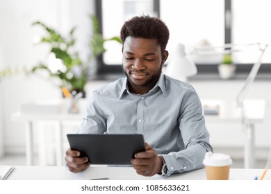 business, people and technology concept - african american businessman with tablet pc computer at office - Shutterstock ID 1085633621