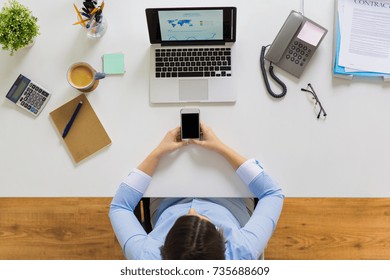 business, people and technology concept - businesswoman with laptop computer and smartphone working at office