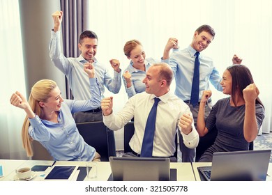 Business, People, Technology, Gesture And Teamwork Concept - Smiling Business Team Raising Hands And Celebrating Victory In Office