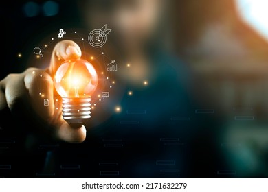 Business People touch Light bulb.Concept of Ideas for Success. Concept with Innovation Invention. Success Starting from a new idea to innovative technology based on data from the Internet, big data. - Shutterstock ID 2171632279